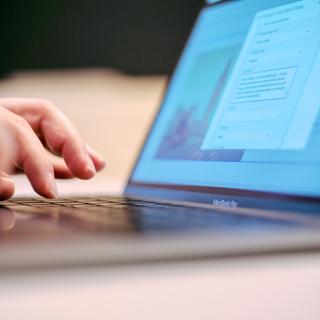 hand typing on laptop