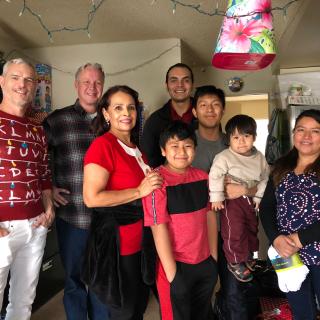 Scali Rasmussen partners John Swenson and Jeffrey Erdman, and Office Manager Steven Sarango (behind camera), delivering gifts to the firms adopted family.