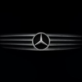 Mercedes-Benz grill with logo, against a black background. 